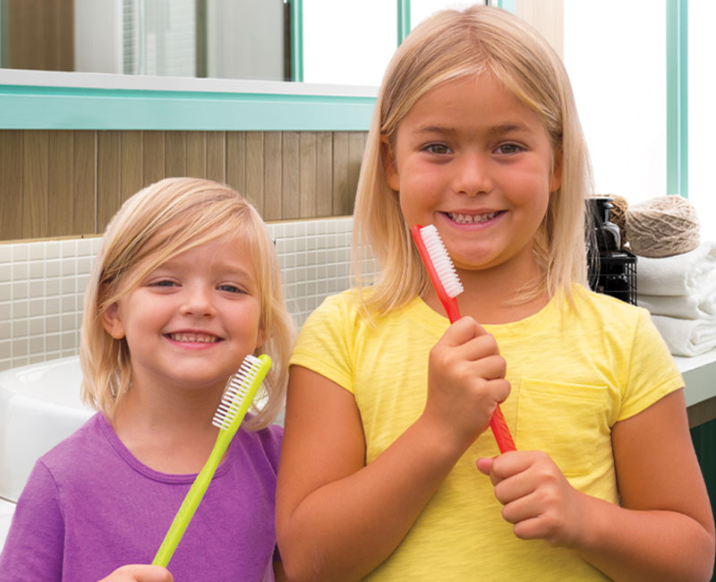 two girls with toothbrushes